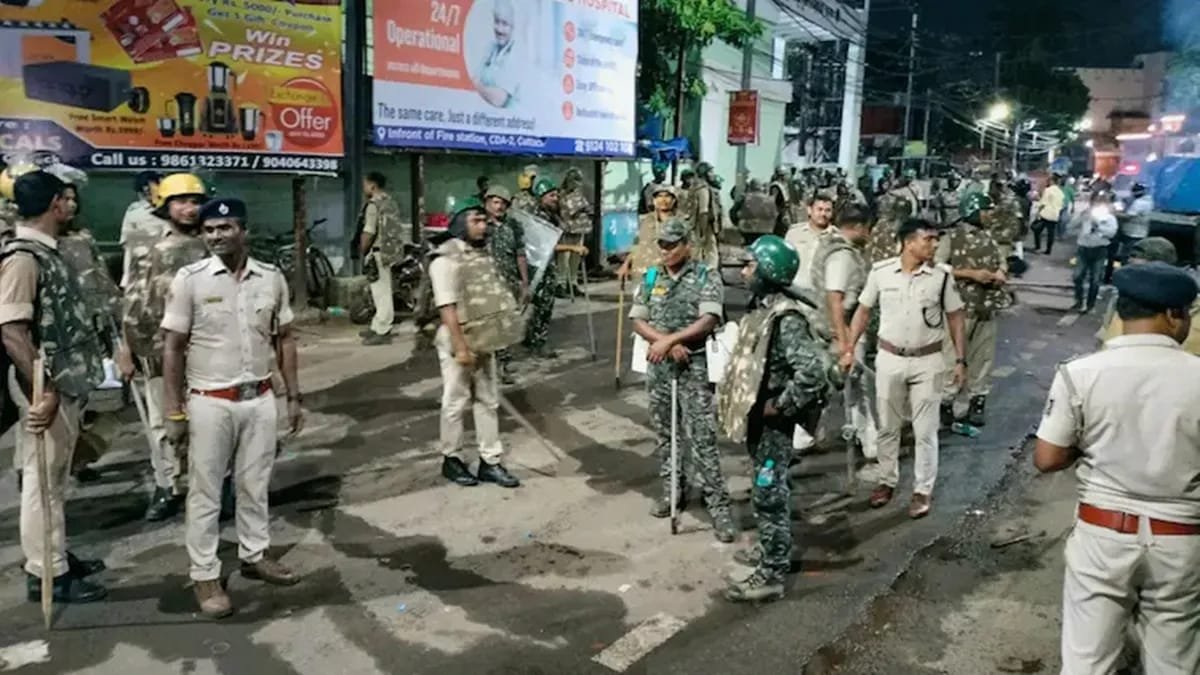 Police personnel deployed on a street in Arambagh, West Bengal, to control tensions following a clash between two neighbourhoods over Durga Puja idol immersion.