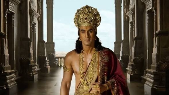 Ranbir Kapoor in Lord Ram look with golden crown and royal attire in a palace.