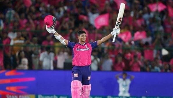 Rajasthan Royals batter Vaibhav Suryavanshi celebrating with bat and helmet raised after scoring.